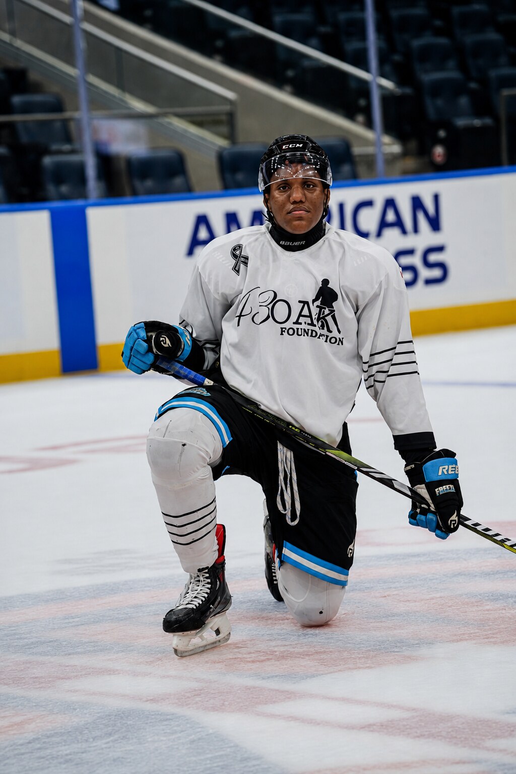 A 43 Oak Foundation athlete kneeling on the ice in a foundation jersey.