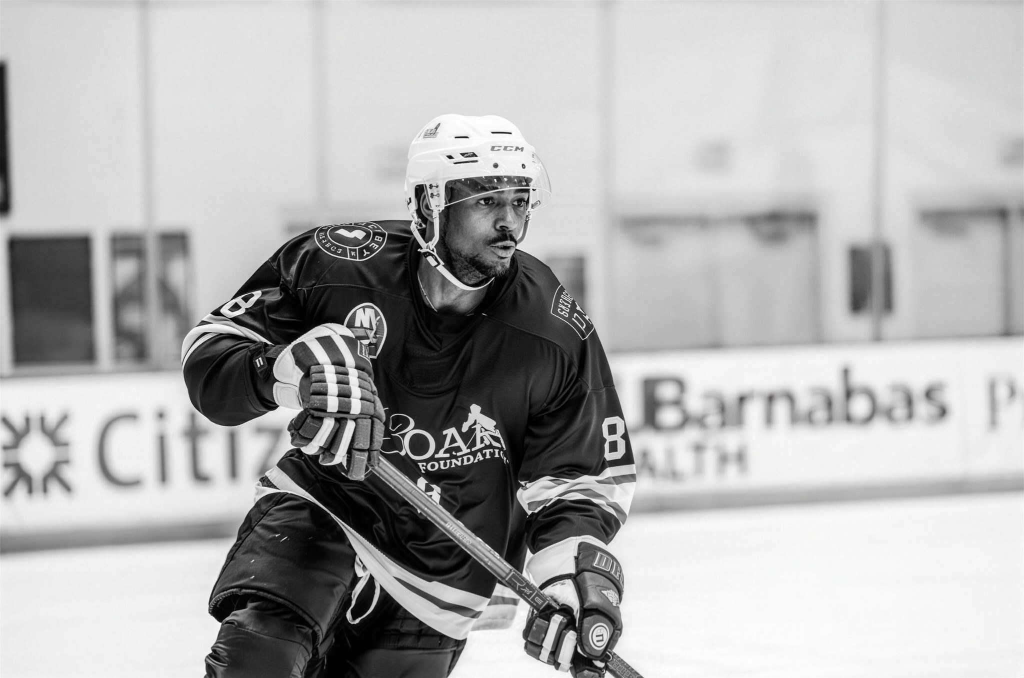 Black-and-white photo of a 43 Oak athlete skating.